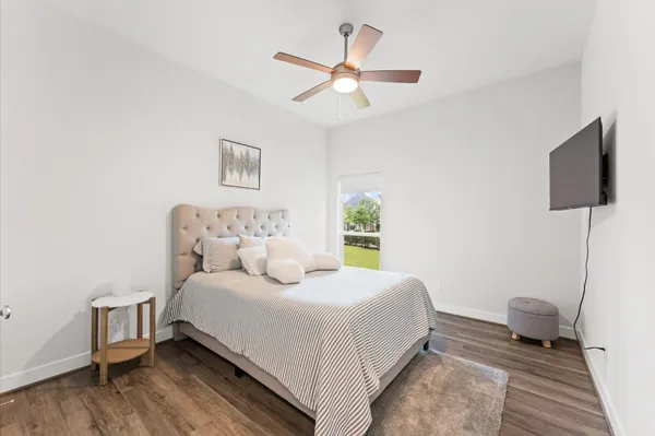 a bedroom with a bed and glass window