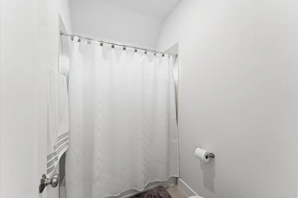 a bathroom with a tub a sink and a mirror