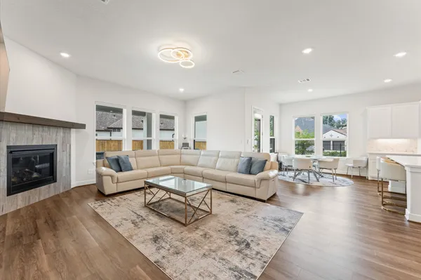 a kitchen with a dining table chairs refrigerator and cabinets
