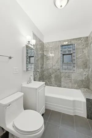 a bathroom with a toilet a sink and bathtub