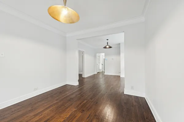 a view of a room with wooden floor