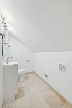 a bathroom with a sink a toilet and mirror