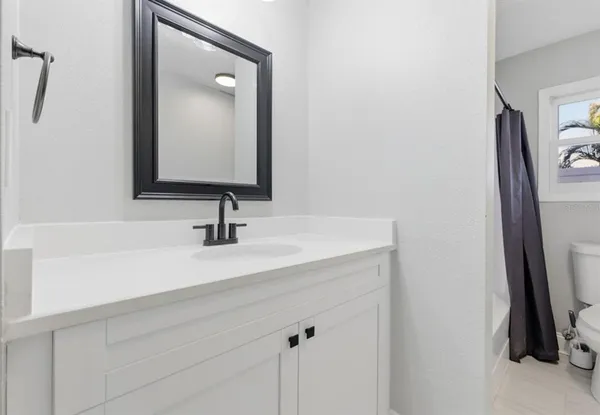 a bathroom with a sink a mirror and a window