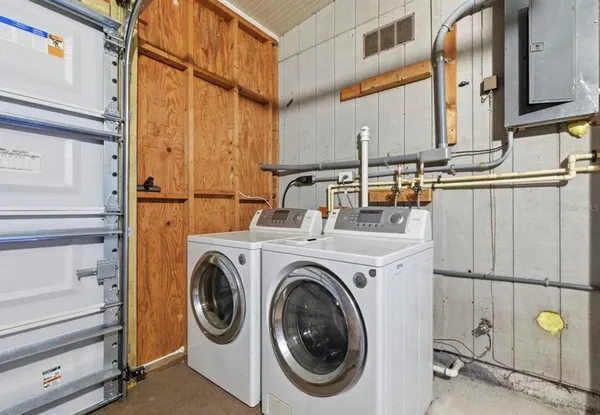 a view of storage and utility room with washer and dryer