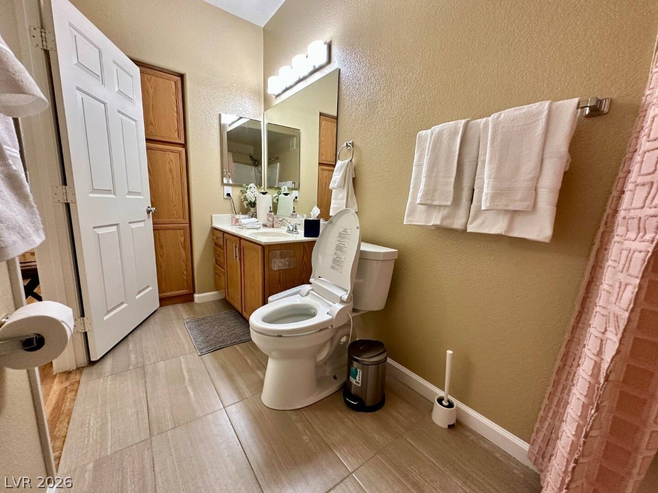 9580 West Reno Avenue, Unit 169 Las Vegas, NV 89148 - Photo 10 of 15 Functional bathroom featuring light-toned flooring and built-in storage solutions.