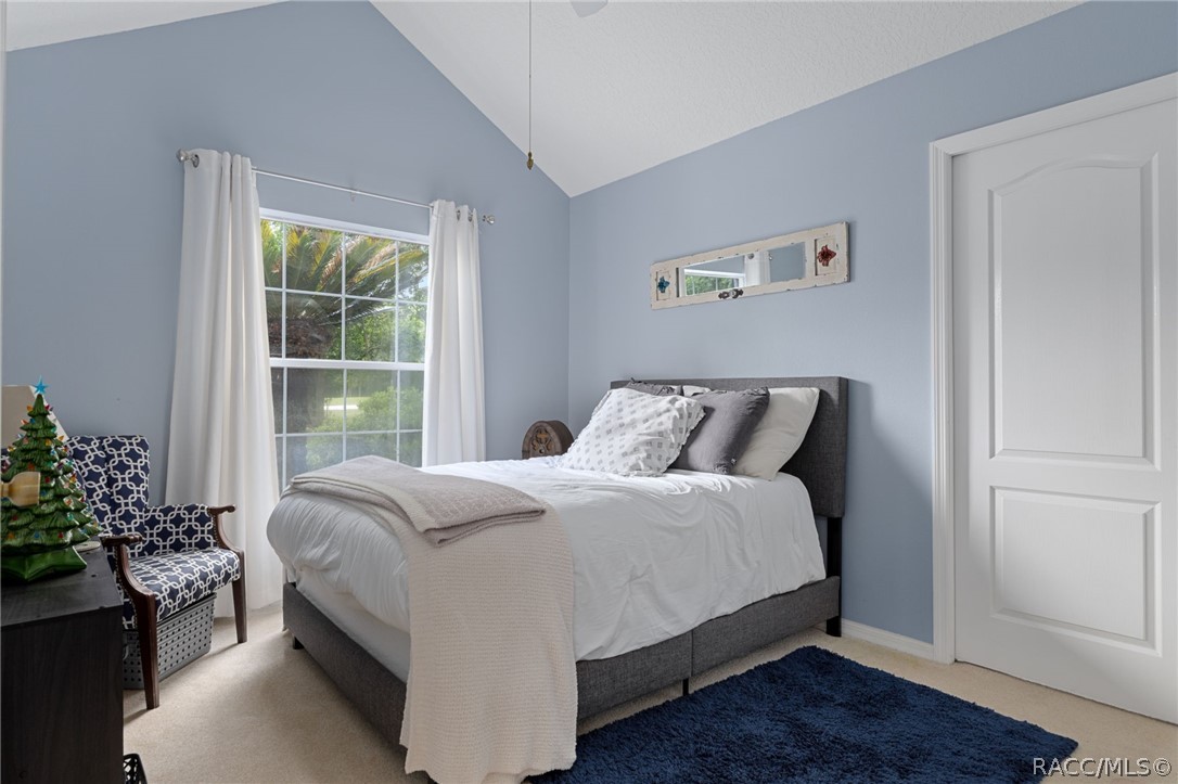 2460 West Pine Ridge Boulevard Beverly Hills, FL 34465 - Photo 16 of 47 a large bed sitting in a bedroom next to a window