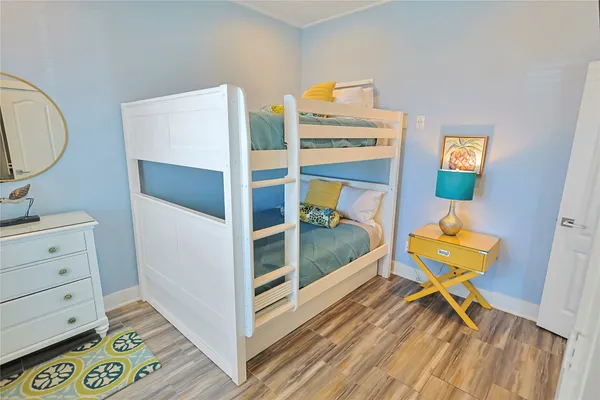 a view of a bedroom with baby bed and furniture