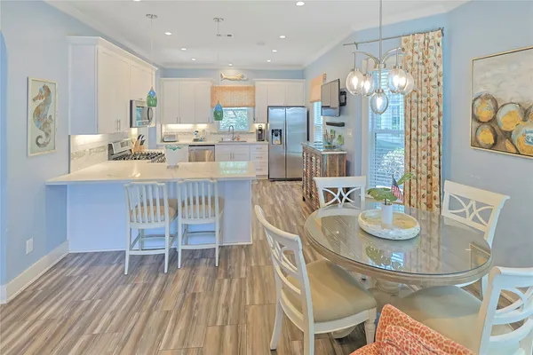 a dining room with furniture and wooden floor