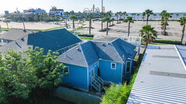 an aerial view of a house with garden space and lake view