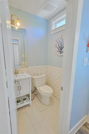 a white toilet sitting next to a bathroom sink