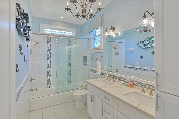 a bathroom with a double vanity sink mirror double and shower