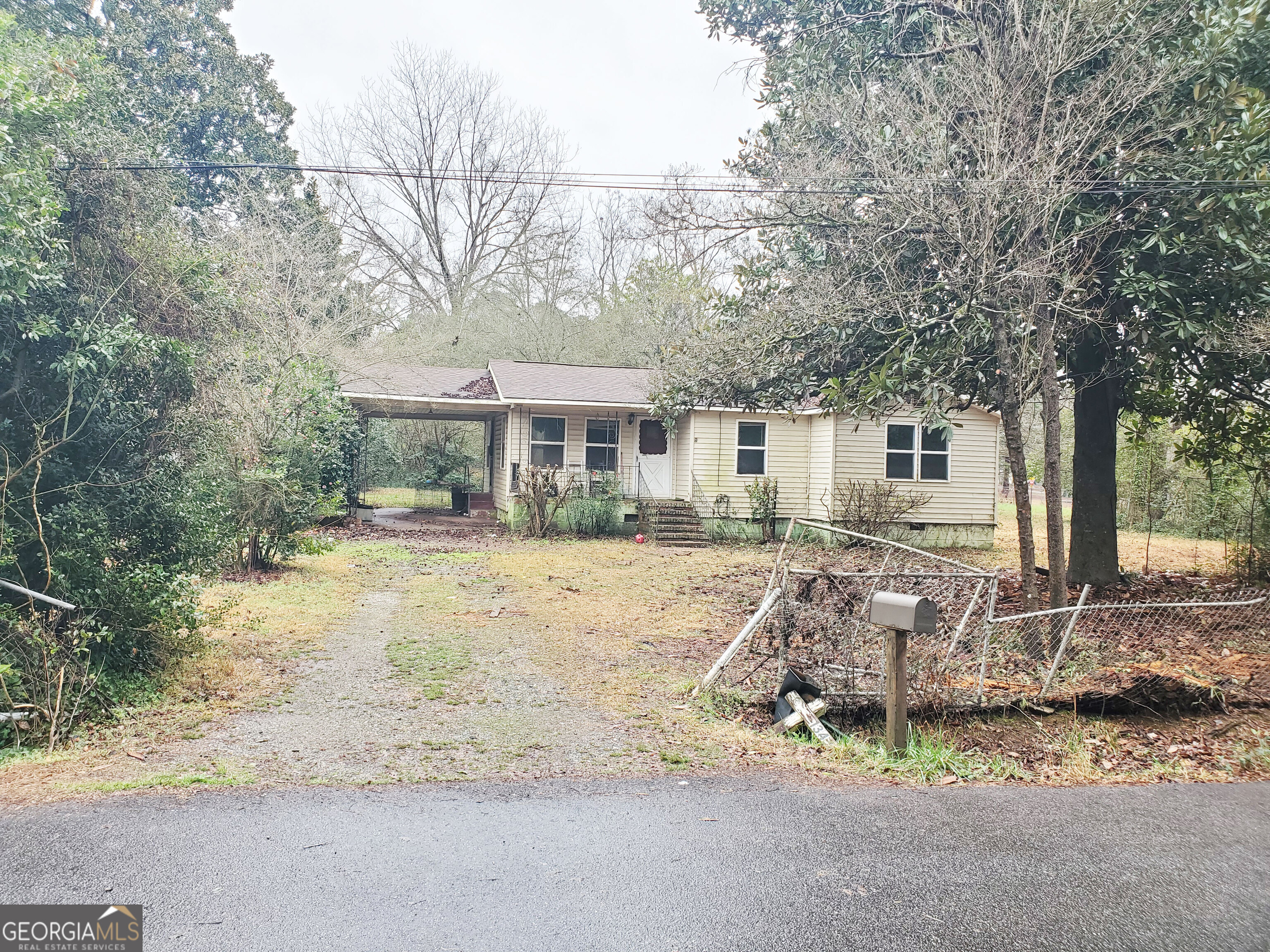 a front view of a house with a yard tree and outdoor seating