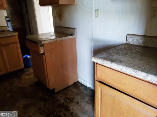 a kitchen with a refrigerator and a stove