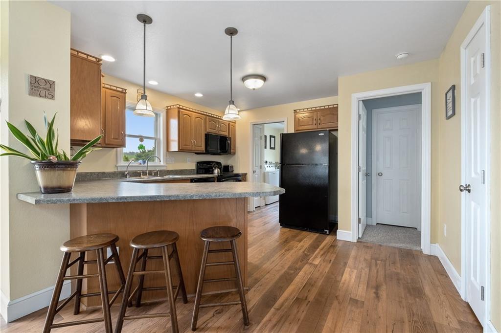 116 Country Lane Road Butler, PA 16001 - Photo 14 of 50 a kitchen with stainless steel appliances granite countertop a refrigerator a stove a sink and a wooden floor