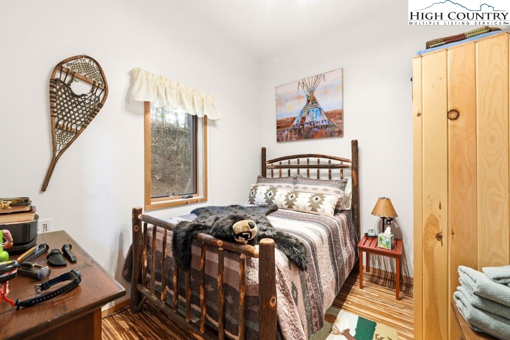 408 Eagle Ridge Road Roan Mountain, TN 37687 - Photo 26 of 45 a bedroom with a bed and a window