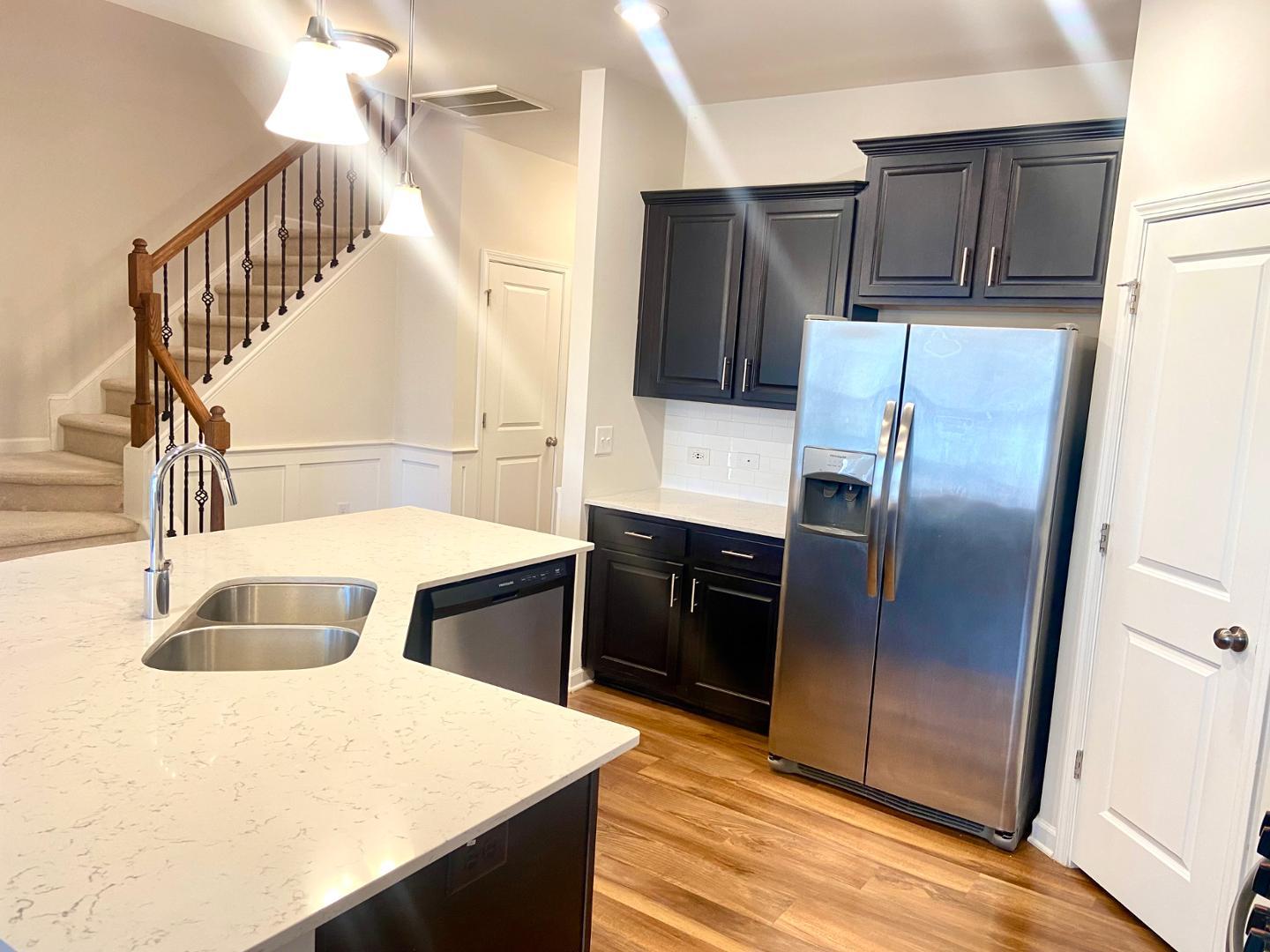 6005 Beale Loop Raleigh, NC 27616 - Photo 3 of 6 a kitchen with kitchen island a counter top space wooden floor and stainless steel appliances