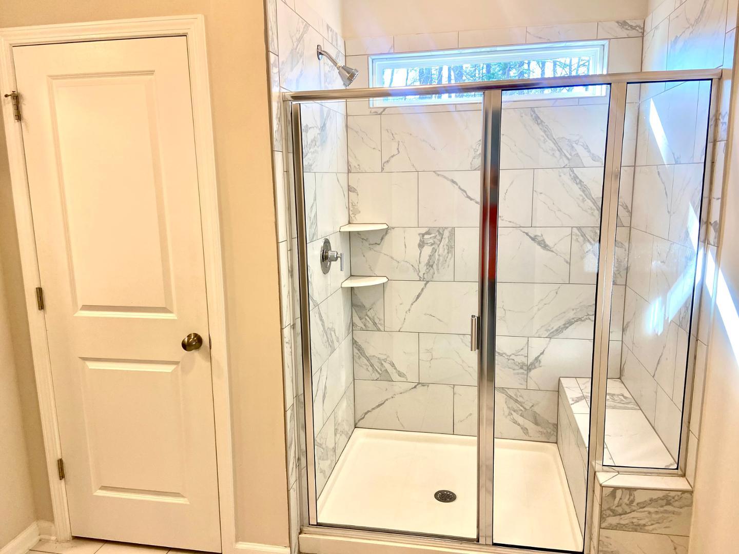 6005 Beale Loop Raleigh, NC 27616 - Photo 4 of 6 a bathroom with a glass shower door