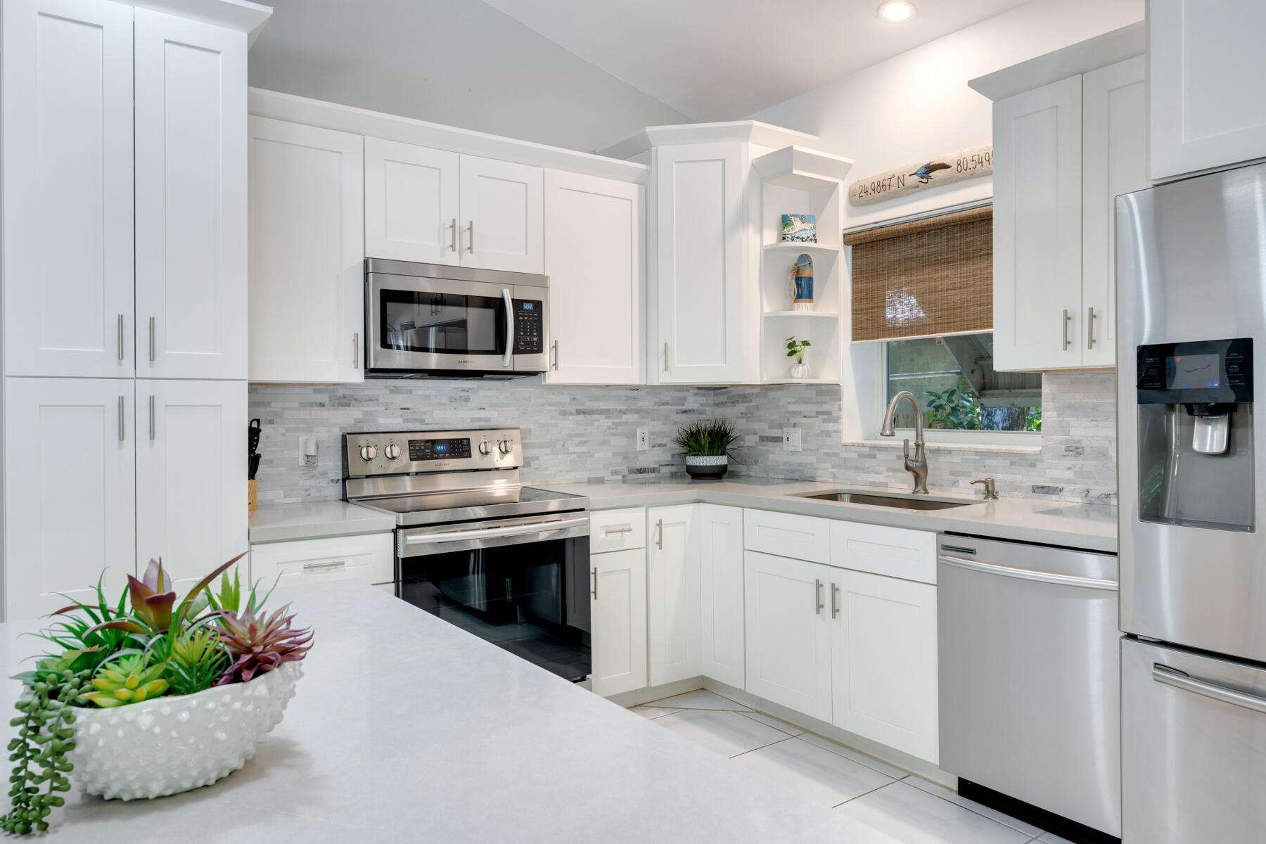 150 Apache Street Tavernier, FL 33070 - Photo 5 of 32 a kitchen with cabinets stainless steel appliances and a sink