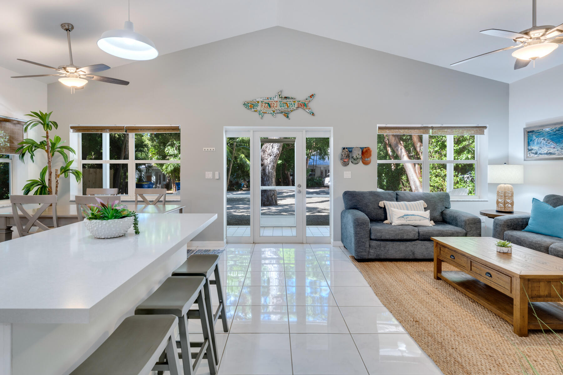 150 Apache Street Tavernier, FL 33070 - Photo 7 of 32 a living room with furniture a chandelier and a dining table