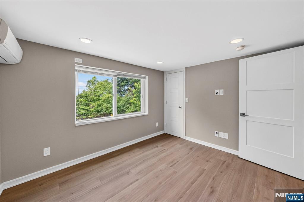 57 Hemlock Road Little Falls, NJ 07424 - Photo 31 of 50 a view of an empty room with wooden floor and a window