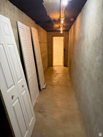 2313 150 East Bountiful, UT 84010 - Photo 32 of 39 Concrete flooring extending through a hallway with exposed concrete walls
