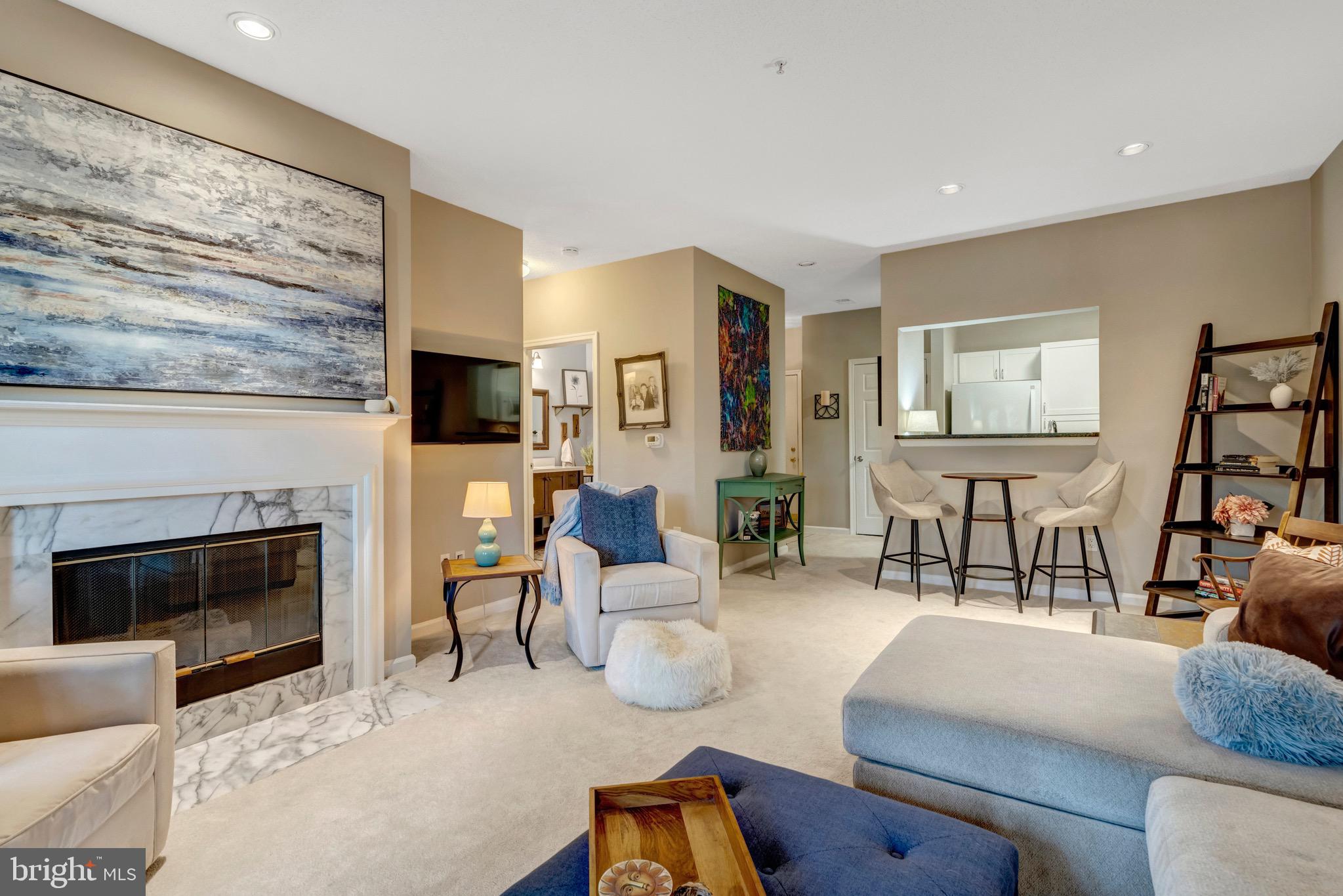 1712 Lake Shore Crest Drive, Unit 14 Reston, VA 20190 - Photo 11 of 24 a living room with furniture wooden floor and a fireplace
