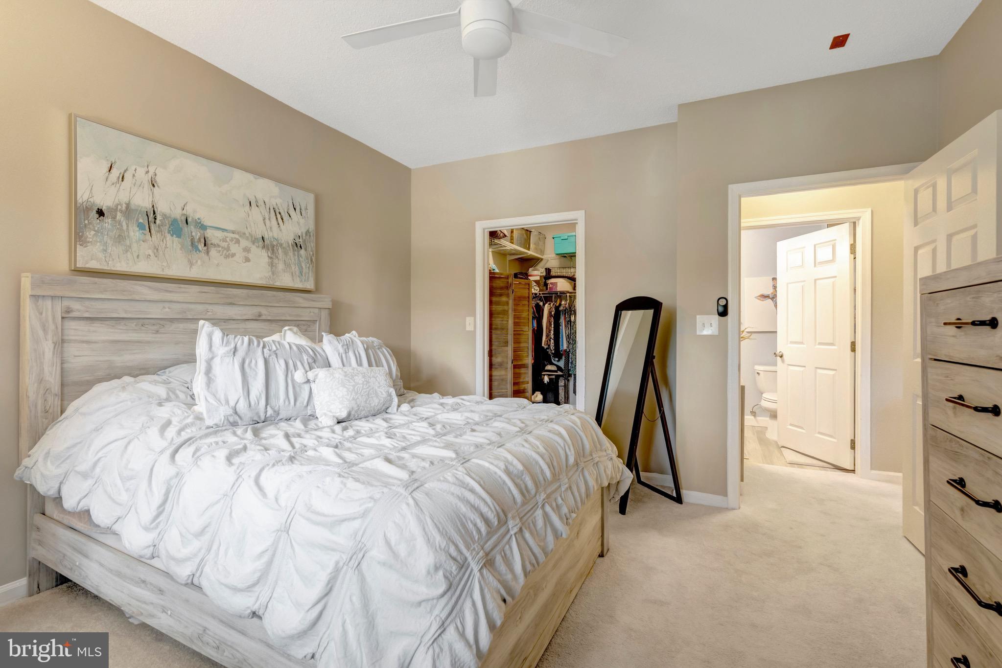 1712 Lake Shore Crest Drive, Unit 14 Reston, VA 20190 - Photo 15 of 24 a bed sitting in a bedroom next to a window