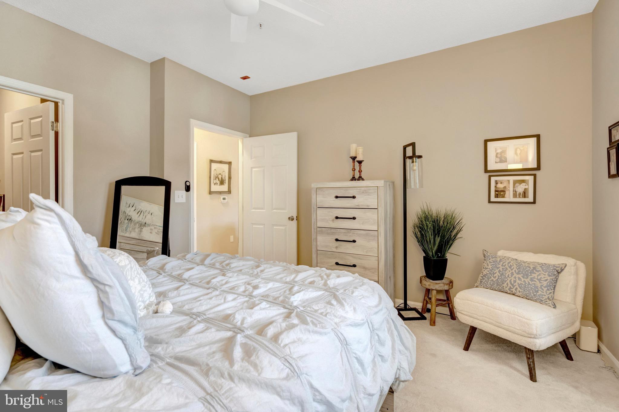 1712 Lake Shore Crest Drive, Unit 14 Reston, VA 20190 - Photo 16 of 24 a bedroom with a bed and a couch