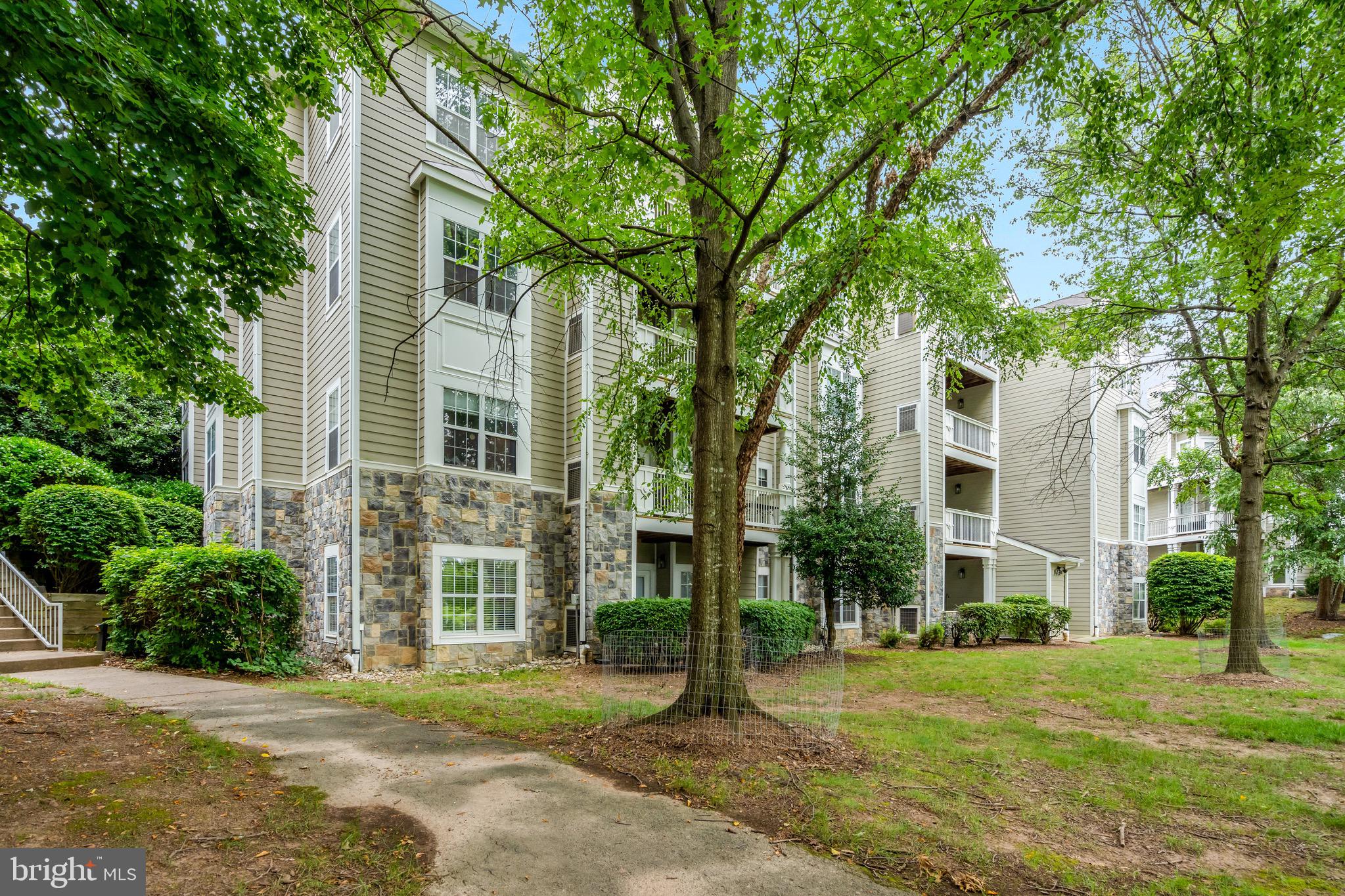 1712 Lake Shore Crest Drive, Unit 14 Reston, VA 20190 - Photo 21 of 24 front view of a house with a yard