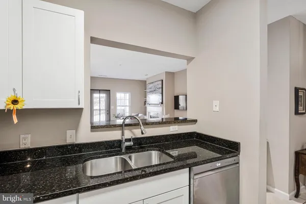 a kitchen with stainless steel appliances a sink and a refrigerator