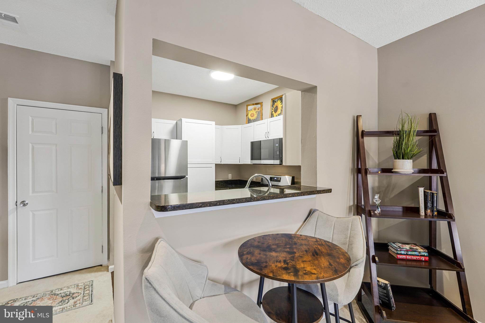 1712 Lake Shore Crest Drive, Unit 14 Reston, VA 20190 - Photo 8 of 24 a kitchen with stainless steel appliances a sink and a refrigerator