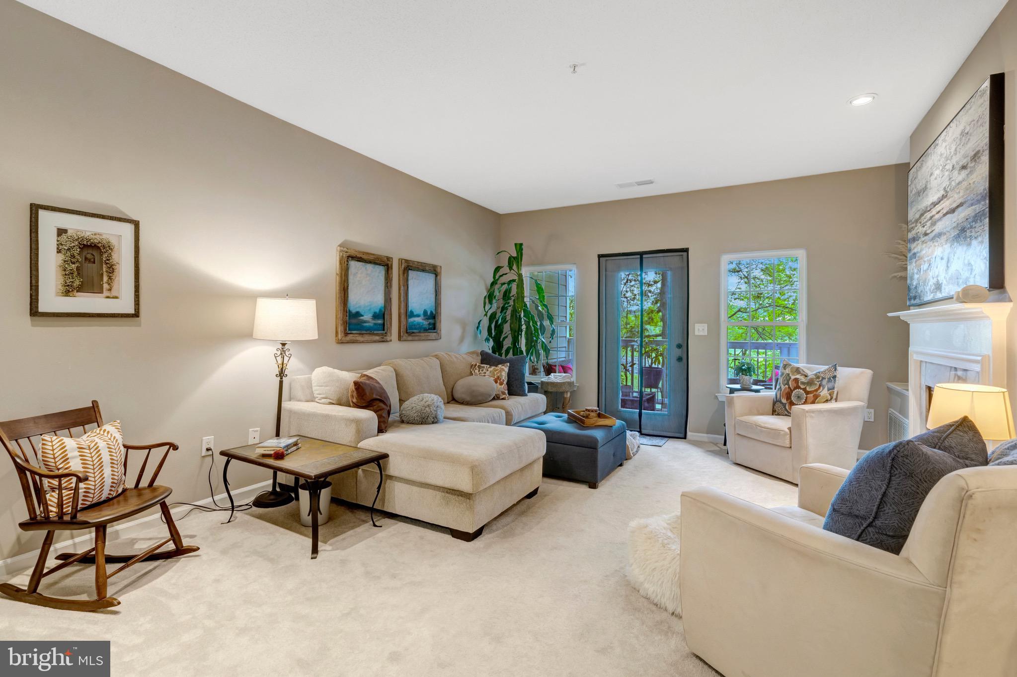 1712 Lake Shore Crest Drive, Unit 14 Reston, VA 20190 - Photo 9 of 24 a living room with furniture and a large window