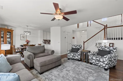a living room with furniture and wooden floor