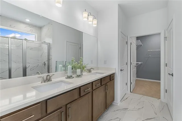 a bathroom with a double vanity sink mirror and shower