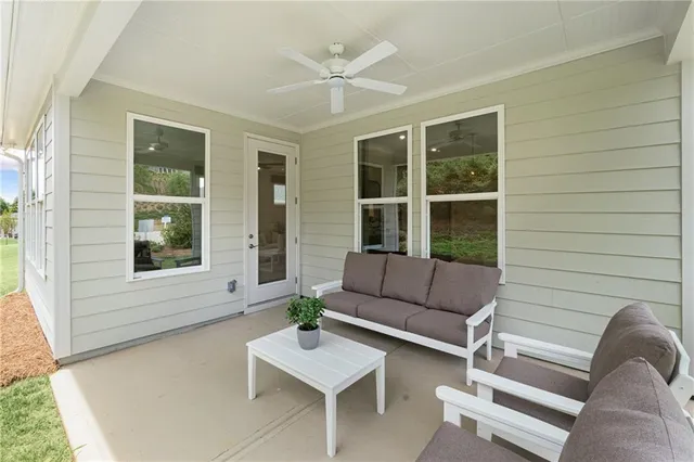 a view of house with couch and a potted plant