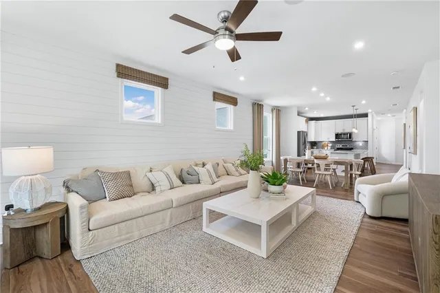 a living room with furniture and view of kitchen
