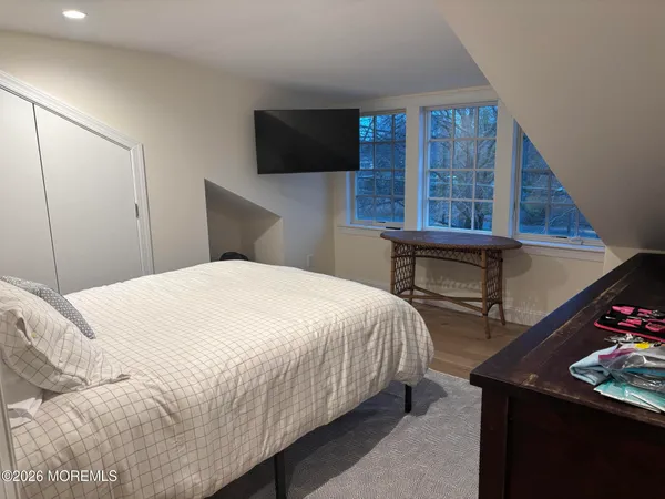 a bedroom with a bed and a television