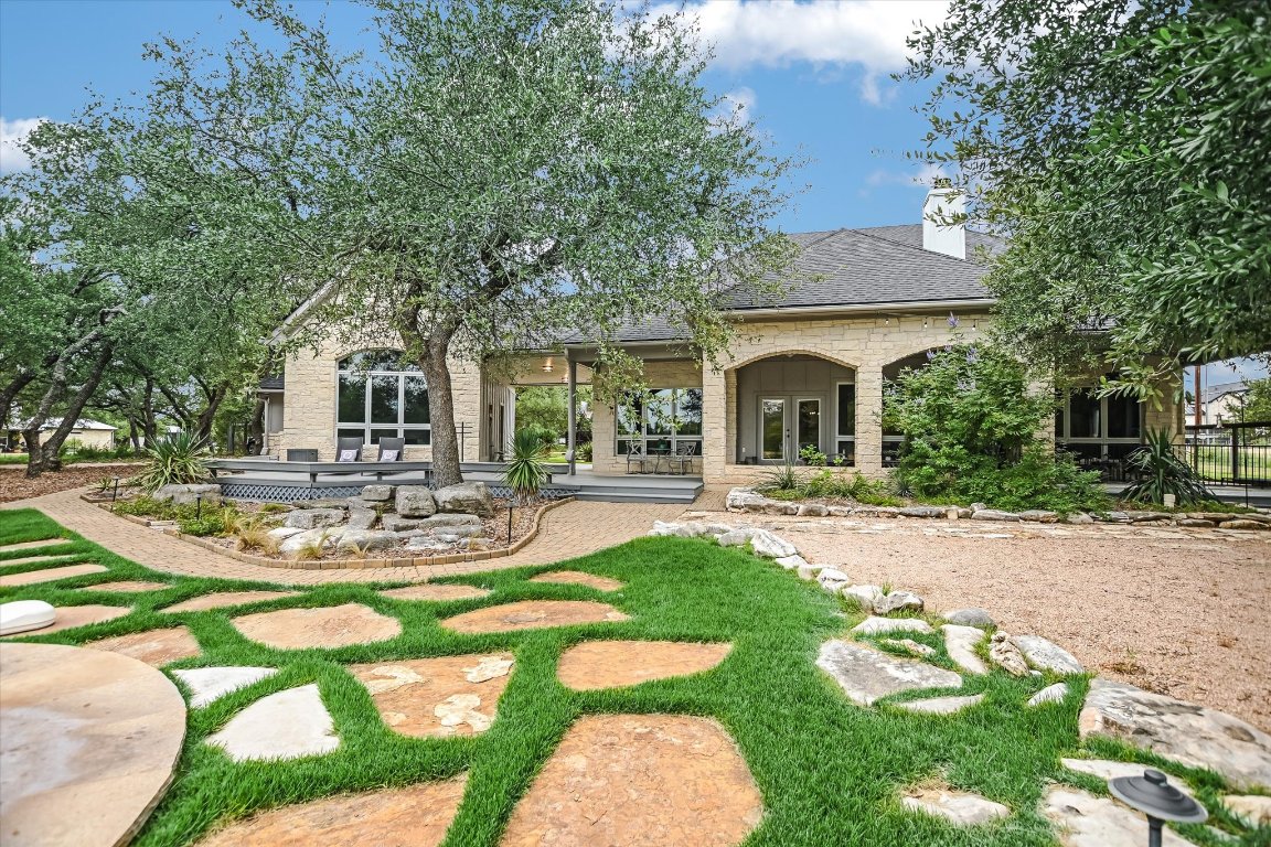 a view of a house with backyard porch and sitting area