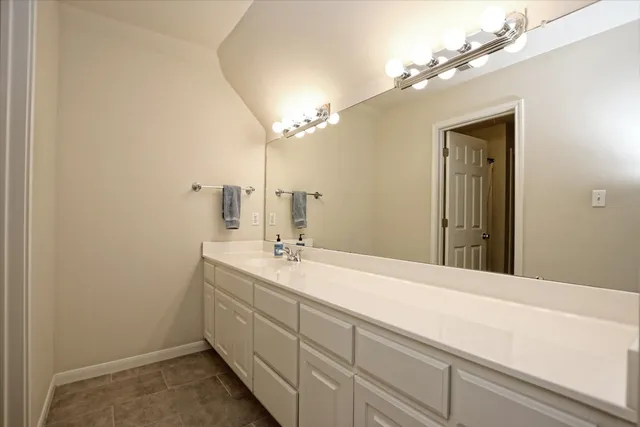 a bathroom with a sink a vanity and a mirror