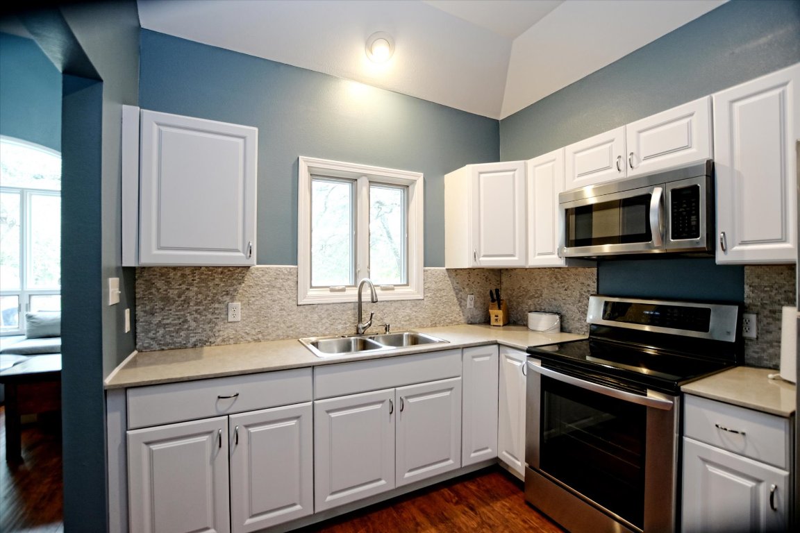 425 Patricia Road Georgetown, TX 78628 - Photo 22 of 30 a kitchen with a sink stove and microwave