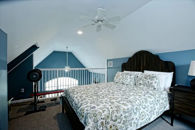 a bedroom with a bed and a ceiling fan