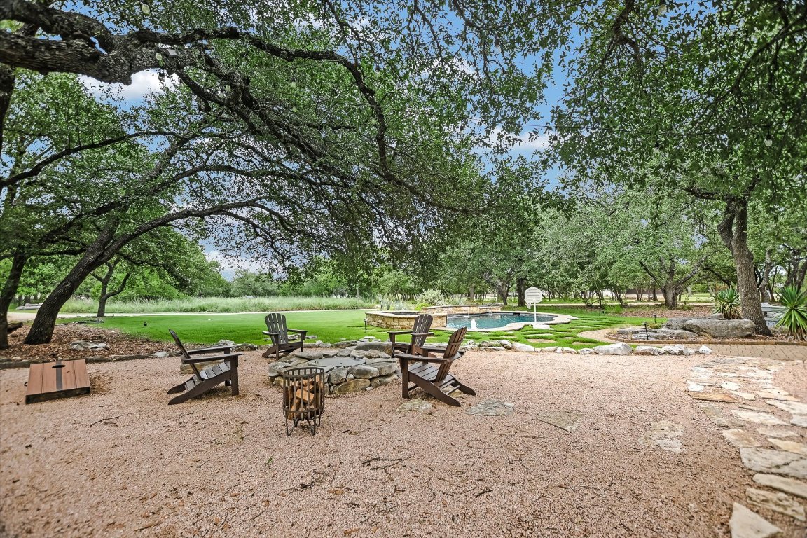 425 Patricia Road Georgetown, TX 78628 - Photo 29 of 30 a view of a lake with a table and chairs under an umbrella