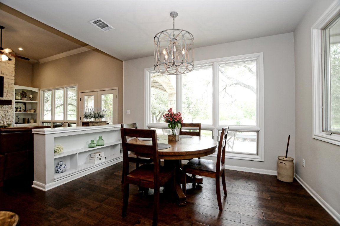 425 Patricia Road Georgetown, TX 78628 - Photo 6 of 30 a dining room with wooden floor a chandelier a wooden table and chairs