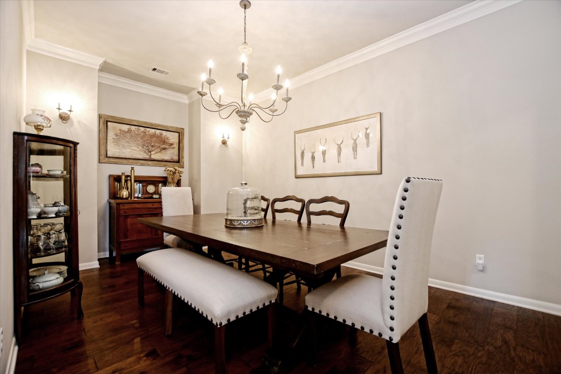 425 Patricia Road Georgetown, TX 78628 - Photo 7 of 30 a dining room with furniture a chandelier and wooden floor