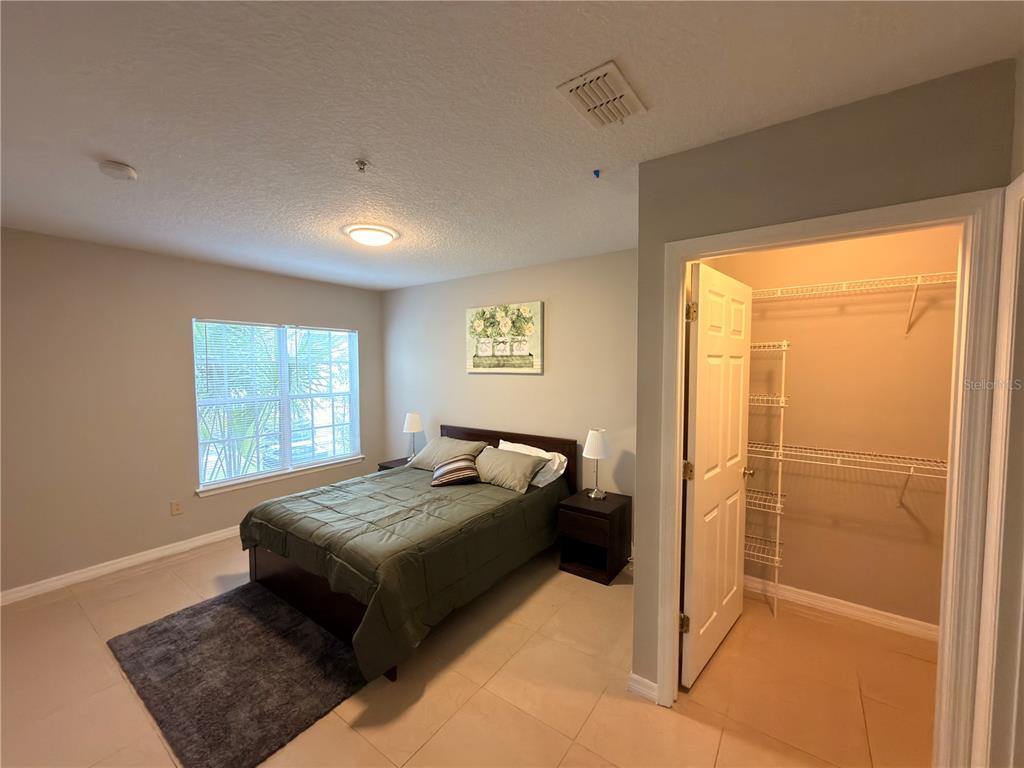 4356 South Kirkman Road, Unit 511 Orlando, FL 32811 - Photo 3 of 9 a bed room with a bed and a window