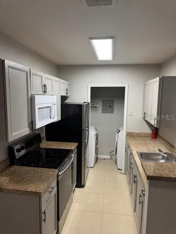 a kitchen that has a sink and a stove in it