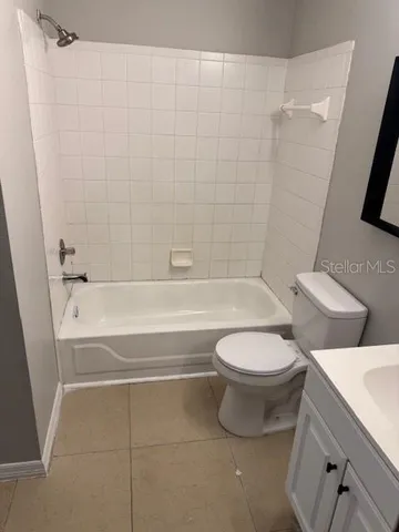 a bathroom with a toilet and a bath tub