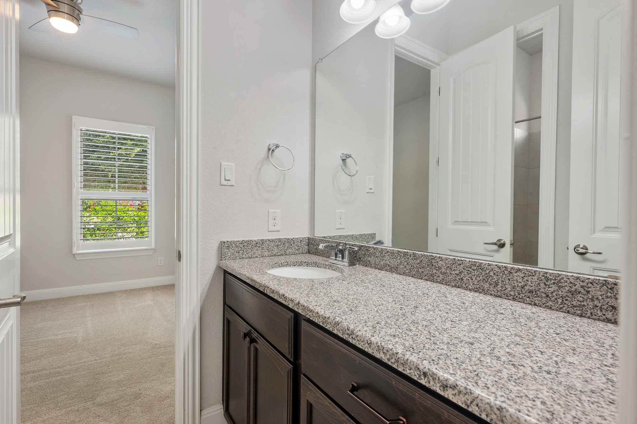 2709 Steece Way Leander, TX 78641 - Photo 37 of 39 a bathroom with a granite countertop sink and a mirror
