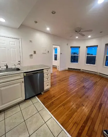 a large kitchen with stainless steel appliances a stove a sink and a refrigerator