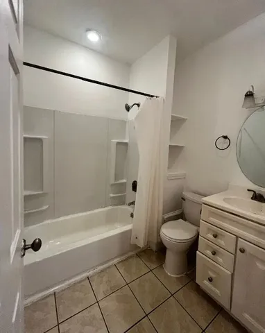 a bathroom with a granite countertop toilet sink and shower